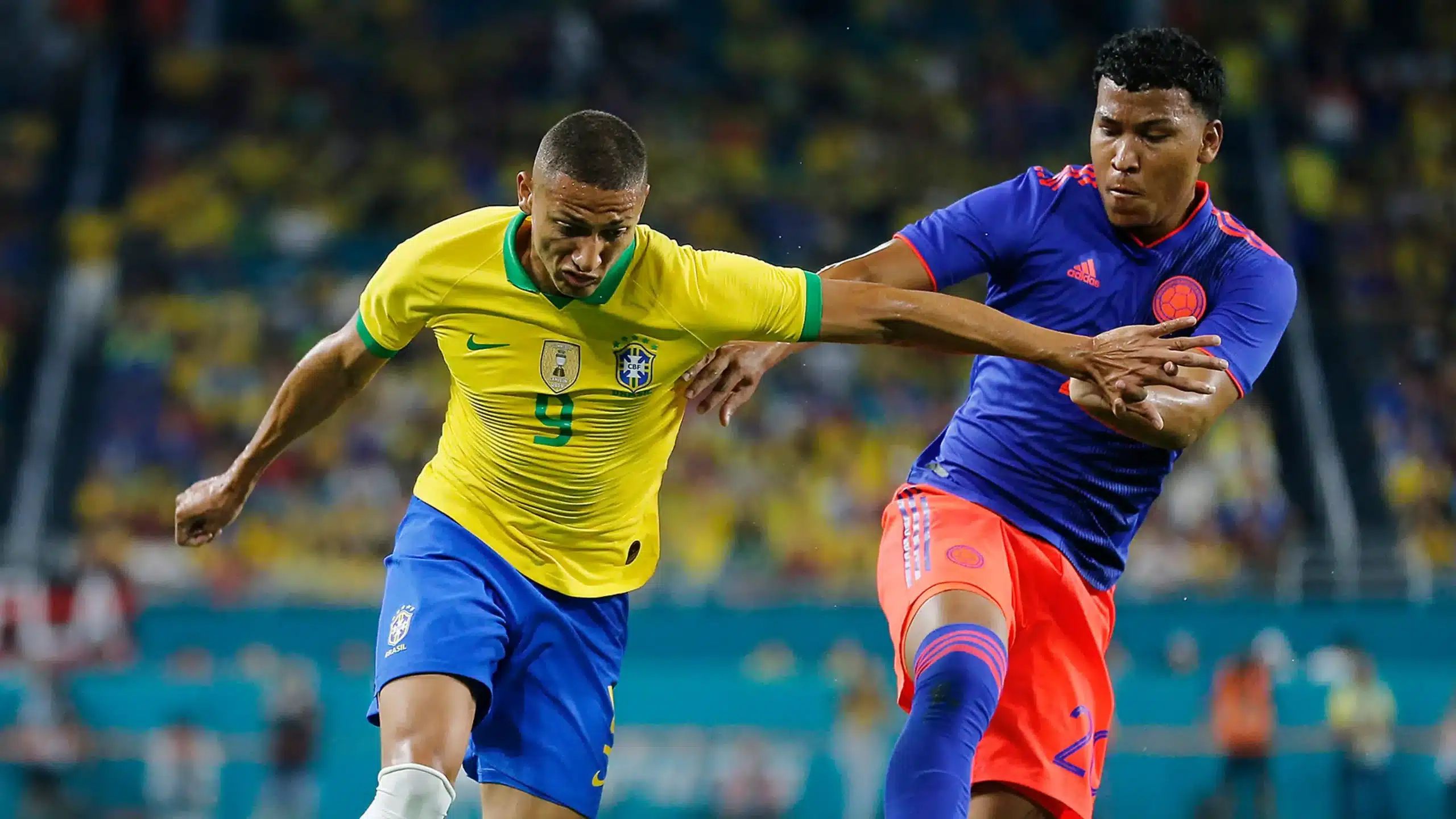 Richarlison de Brasil y Roger Martínez de Colombia disputando un balón