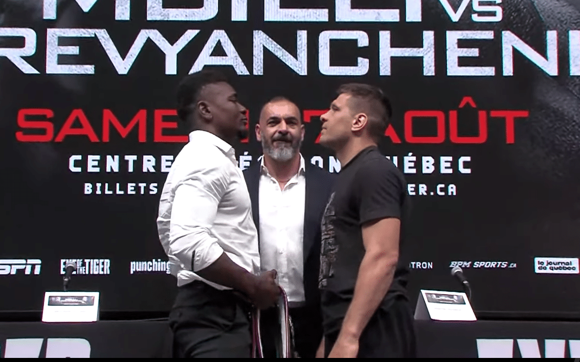 CHRISTIAN MBILLI A LA IZQUIERDA Y SERGIY DEREVYANCHENKO A LA DERECHA, CARA A CARA EN LA PRESENTACIÓN DEL COMBATE EN CANADÁ
